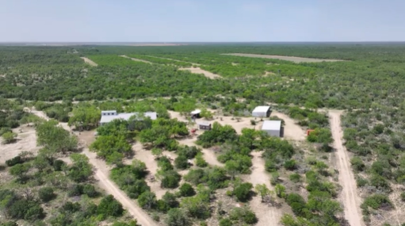 Aerial view of a working ranch spread across open West Texas country
