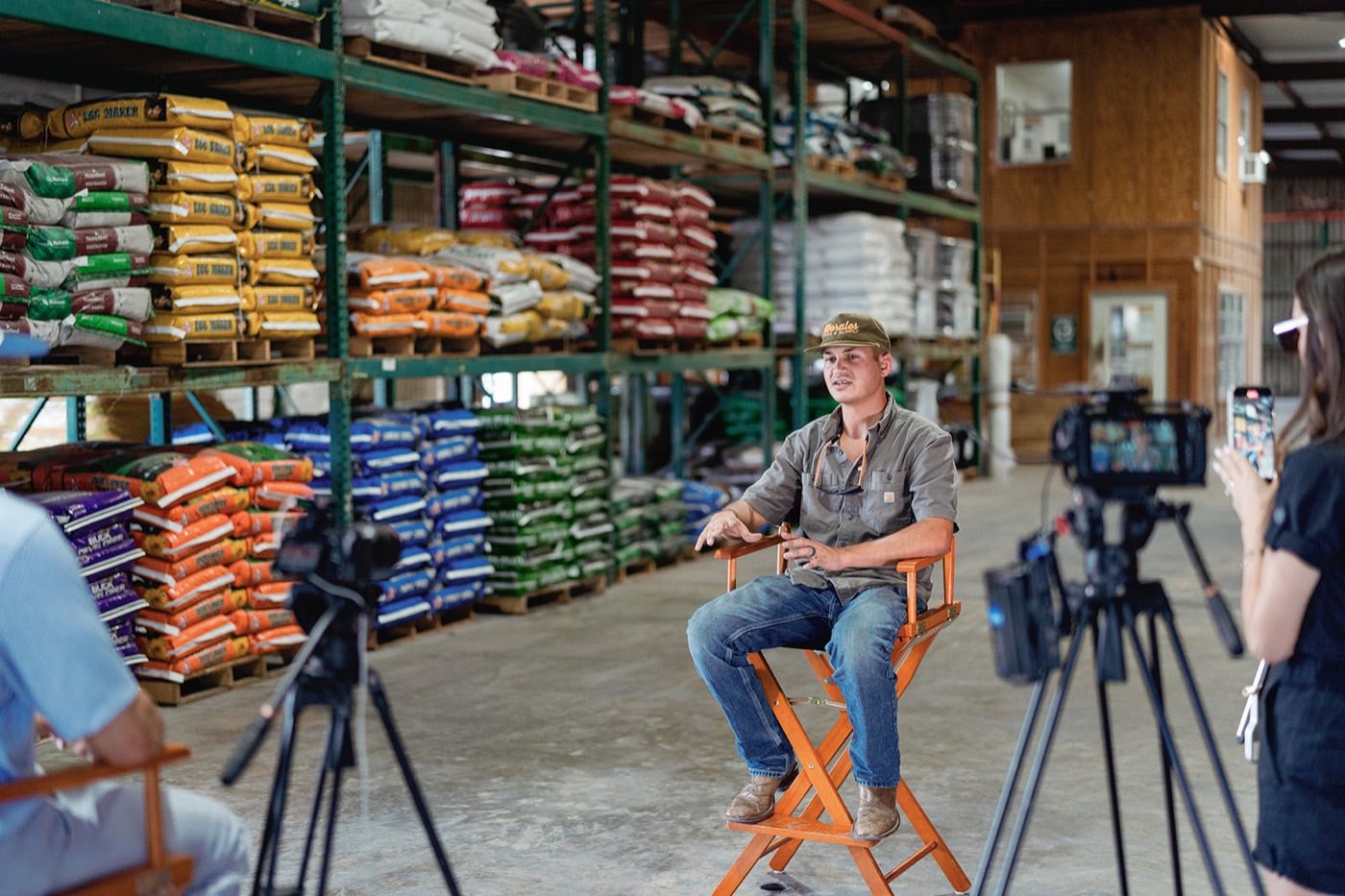 A Deer Camp Digital crew filming a seated interview inside a feed store